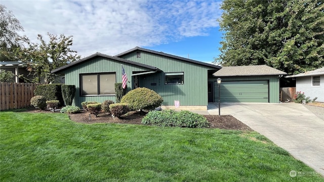 view of front of house featuring a garage and a front lawn