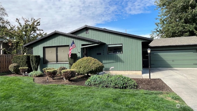 view of front of property with a garage and a front yard