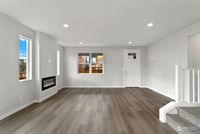 unfurnished living room featuring hardwood / wood-style flooring