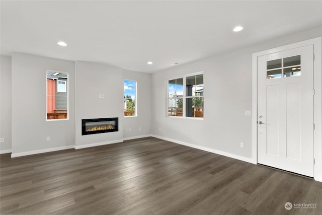 unfurnished living room with dark hardwood / wood-style flooring