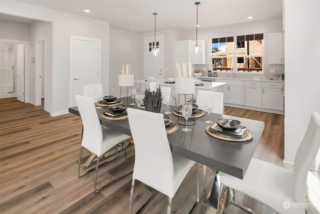 dining area featuring wood-type flooring and sink