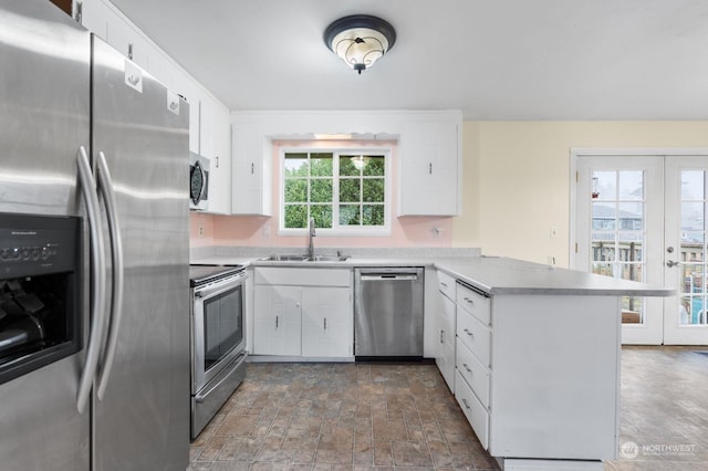 kitchen with kitchen peninsula, white cabinetry, and stainless steel appliances