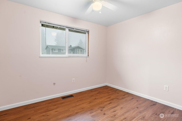 empty room with ceiling fan and wood-type flooring