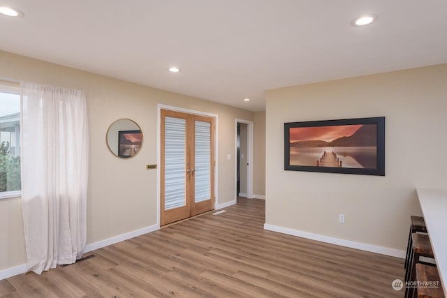 foyer featuring wood-type flooring and french doors