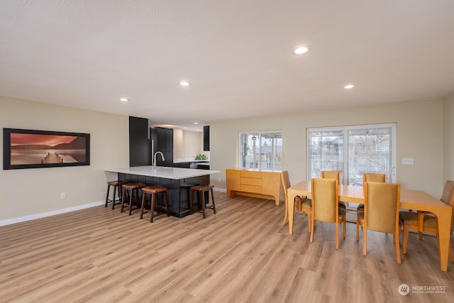 dining room featuring light wood-type flooring and sink