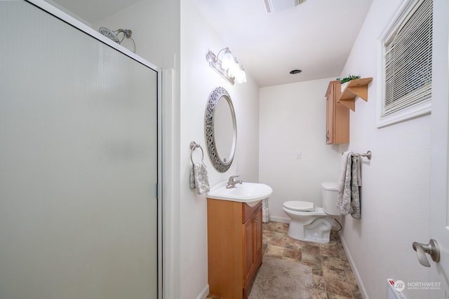 bathroom with vanity, toilet, and walk in shower