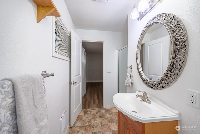 bathroom with vanity and a shower with shower door