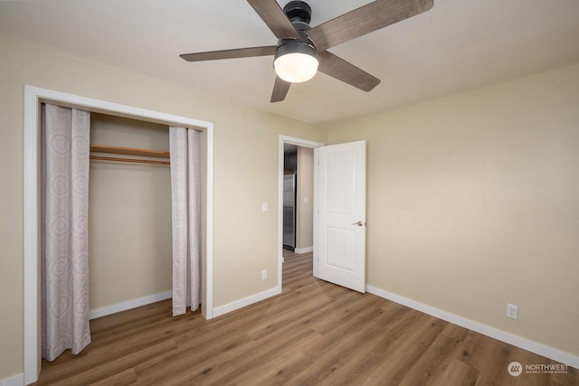 unfurnished bedroom featuring a closet, ceiling fan, and hardwood / wood-style floors