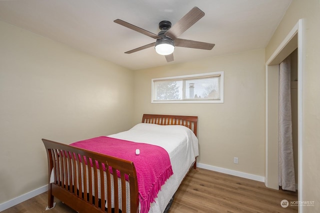 bedroom with ceiling fan and wood-type flooring