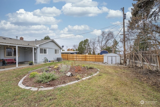 view of yard featuring a shed and central AC unit