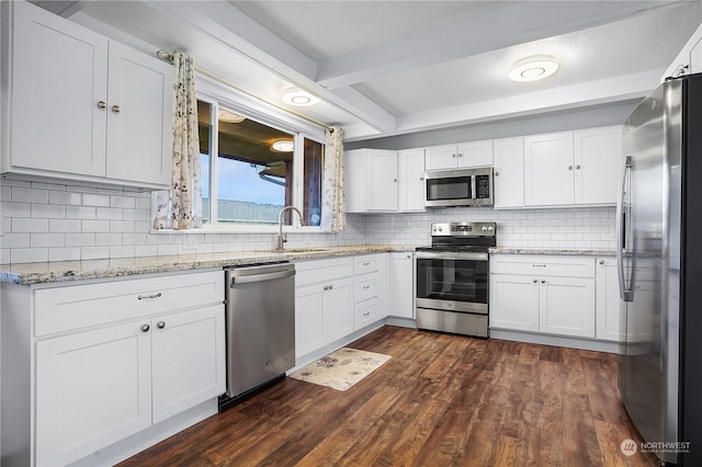 kitchen featuring white cabinets, stainless steel appliances, and dark wood-type flooring