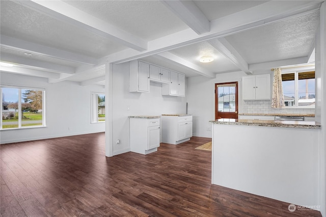 kitchen featuring white cabinets, dark hardwood / wood-style floors, beam ceiling, and decorative backsplash