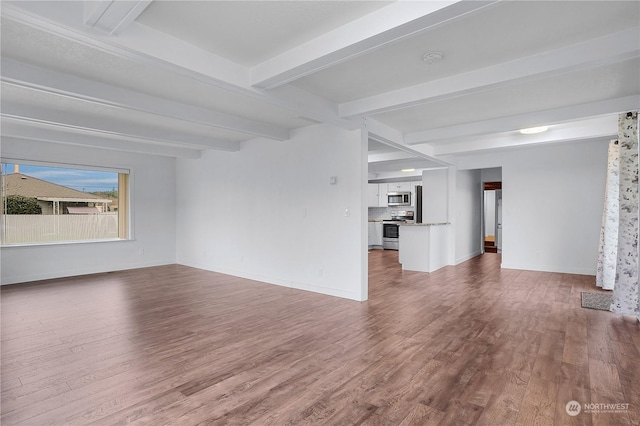 unfurnished living room featuring beamed ceiling and hardwood / wood-style flooring