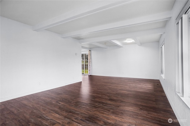 unfurnished room featuring hardwood / wood-style floors and beam ceiling