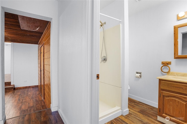 bathroom featuring a shower, vanity, and wood-type flooring