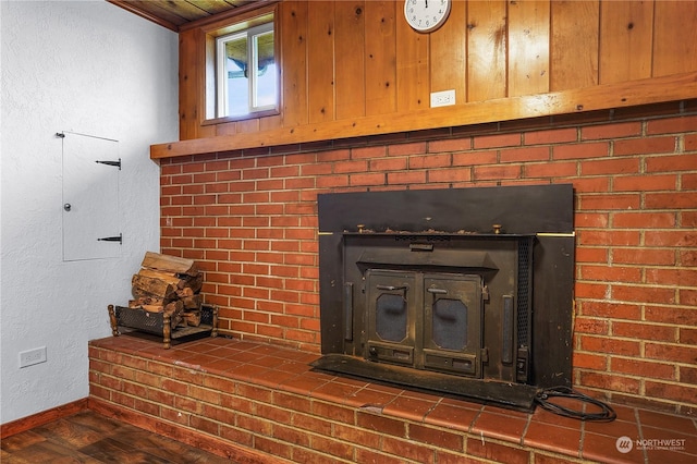 interior details with hardwood / wood-style floors and a wood stove