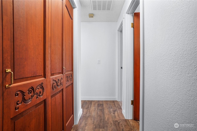 hallway with dark hardwood / wood-style floors