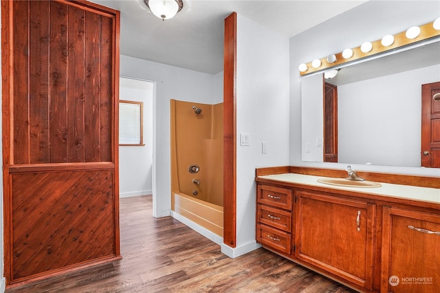 bathroom with vanity, wood-type flooring, and bathtub / shower combination