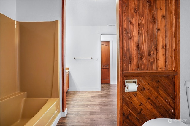 bathroom with wood-type flooring, vanity, and toilet