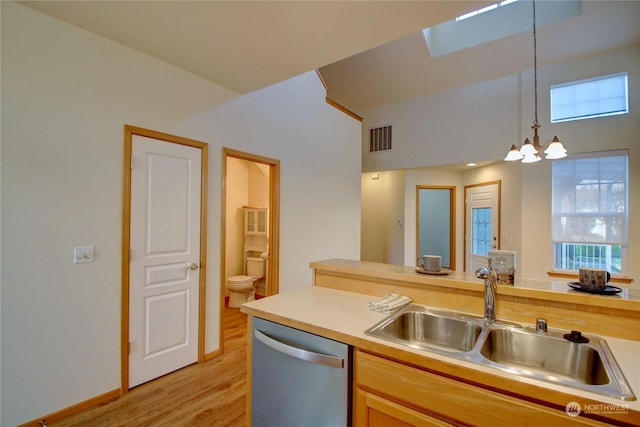 kitchen with sink, stainless steel dishwasher, a notable chandelier, light hardwood / wood-style floors, and decorative light fixtures