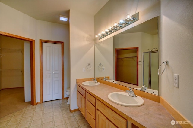 bathroom with vanity, toilet, and walk in shower