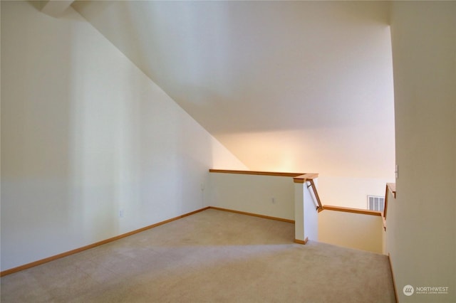 staircase featuring carpet flooring and lofted ceiling