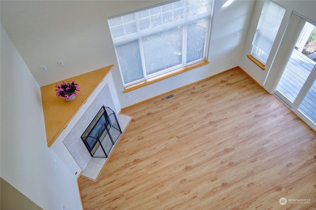 unfurnished living room featuring a fireplace and light hardwood / wood-style flooring