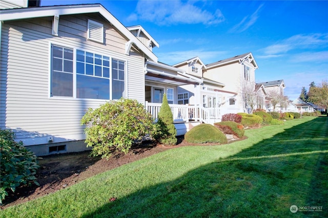 view of property exterior featuring a lawn