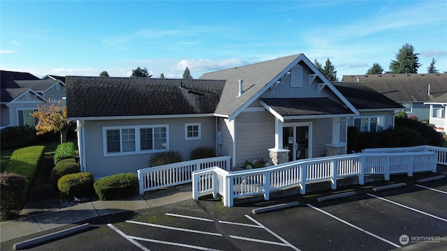 rear view of property with french doors and a wooden deck