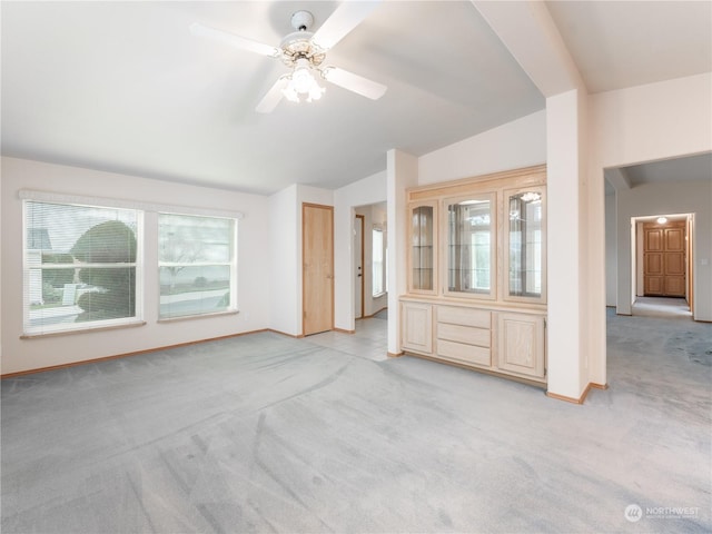 unfurnished living room with light carpet, ceiling fan, and lofted ceiling