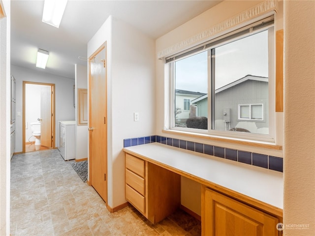 bathroom with toilet, washer and clothes dryer, and lofted ceiling