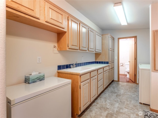 washroom with washer / clothes dryer and sink