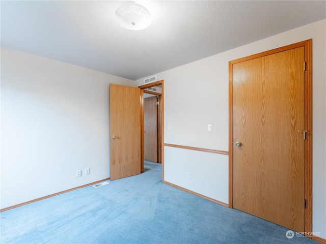 unfurnished bedroom featuring light colored carpet