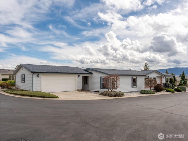 ranch-style home with concrete driveway and a garage