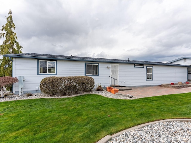 rear view of property with a patio area and a lawn