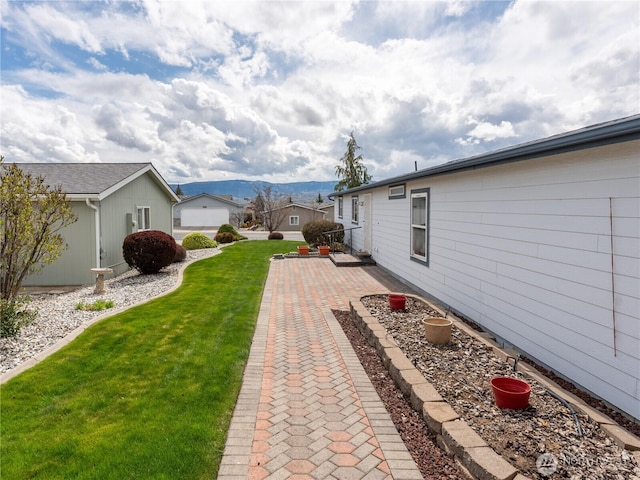 view of yard with a patio and a mountain view
