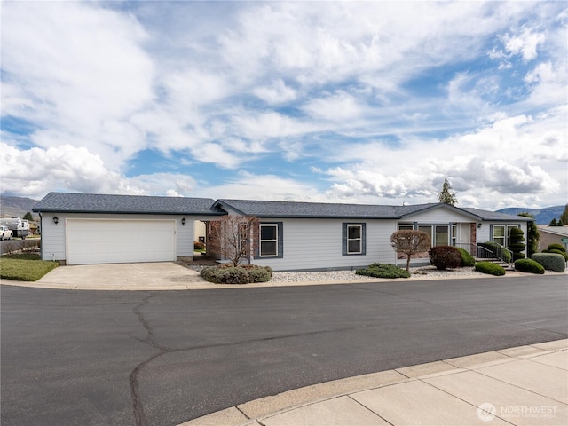 ranch-style home with an attached garage and driveway