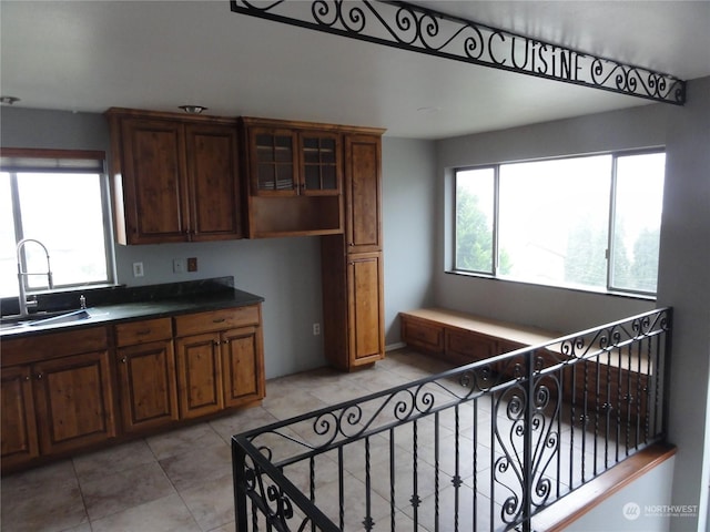 kitchen featuring light tile patterned floors and sink