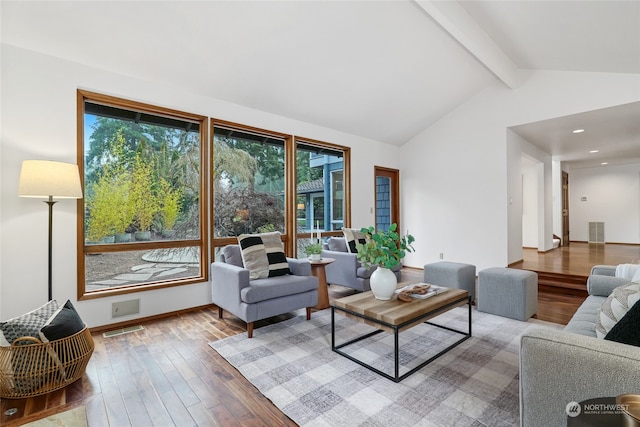 living room featuring hardwood / wood-style floors and lofted ceiling with beams