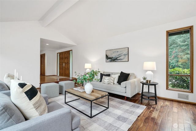 living room featuring wood-type flooring, lofted ceiling with beams, and a healthy amount of sunlight