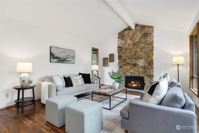 living room with dark wood-type flooring, vaulted ceiling with beams, and a stone fireplace