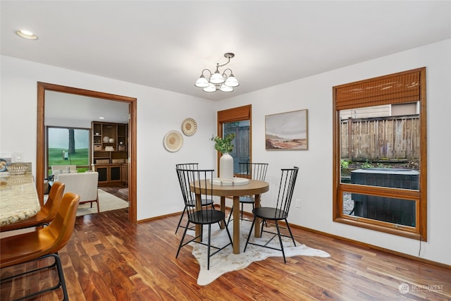 dining room featuring dark wood-type flooring and a notable chandelier