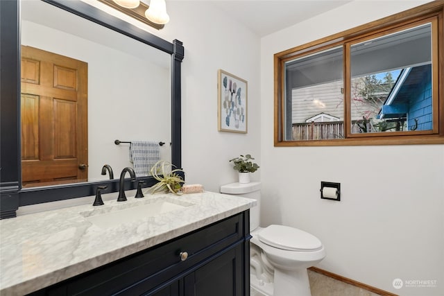 bathroom featuring toilet and vanity