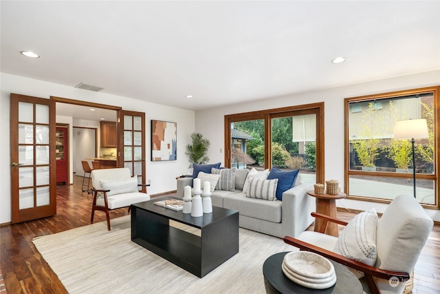 living room with hardwood / wood-style floors and french doors