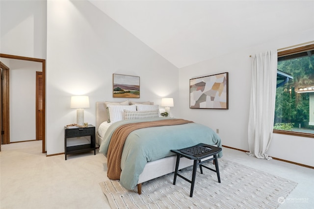 carpeted bedroom featuring high vaulted ceiling and multiple windows