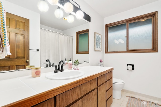 bathroom with toilet, tile patterned floors, and vanity