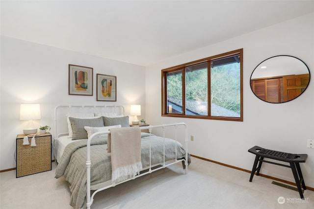 bedroom featuring light colored carpet