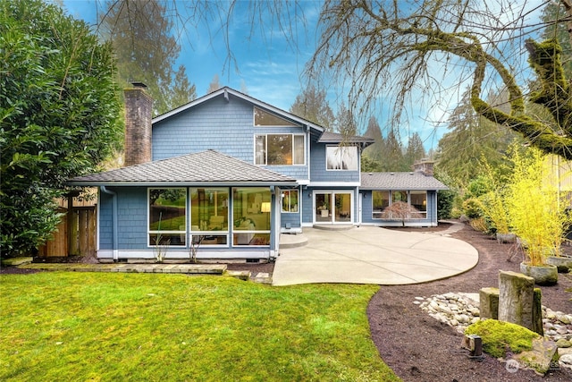 back of property featuring a lawn and a patio area