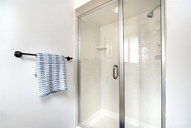 bathroom with a shower with shower door