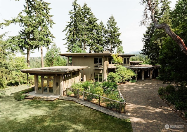 rear view of house featuring a yard